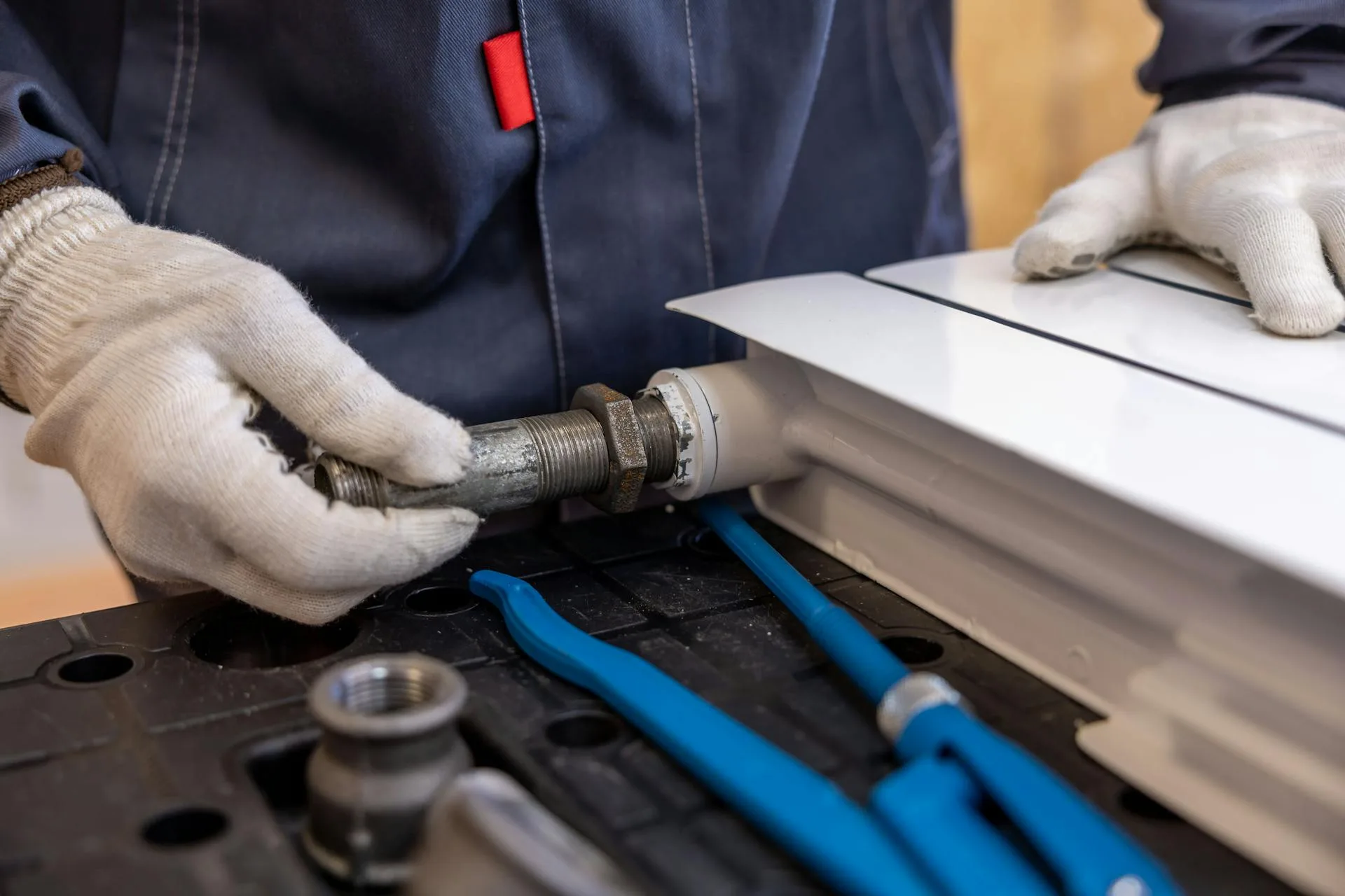 Plumber installing pipes for a plumbing job